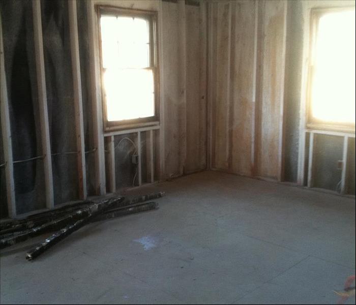 only the wall frames and studs are shown in this photo, which is the beginning of restoring a fire damaged home