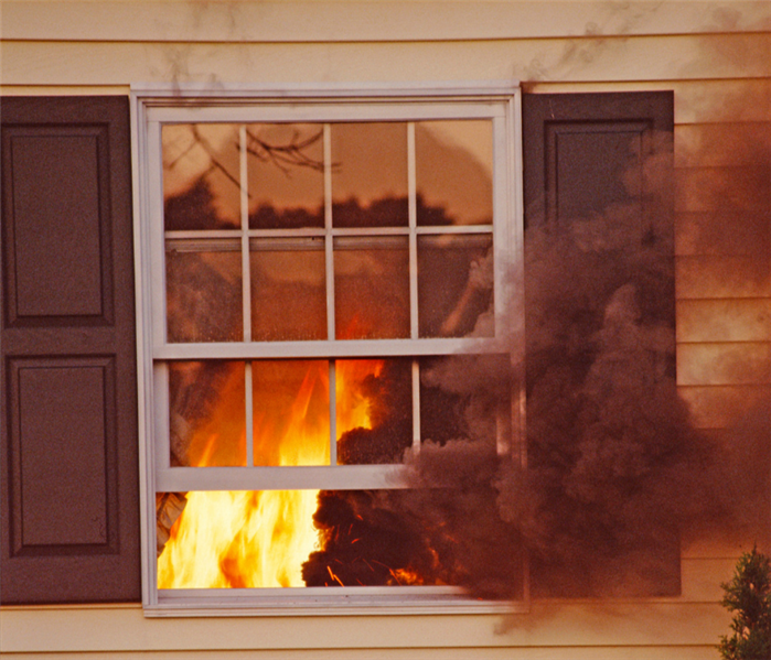 photo of fire inside house looking through window